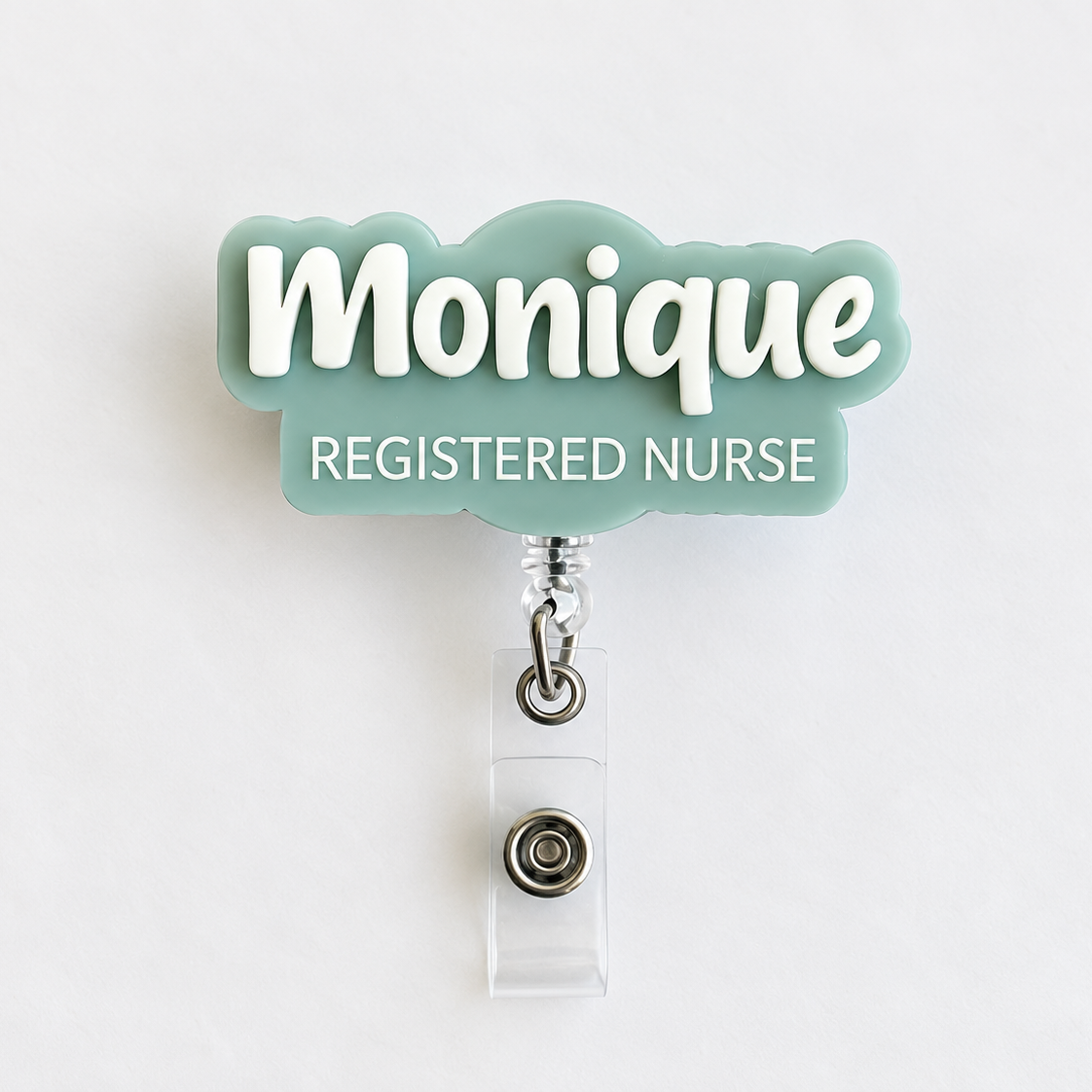 Personalised sage acrylic name badge reel with 'Monique' in raised white 3D lettering and 'Registered Nurse' underneath