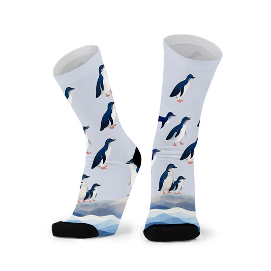 Colourful bamboo socks featuring fairy penguins on a light blue background.