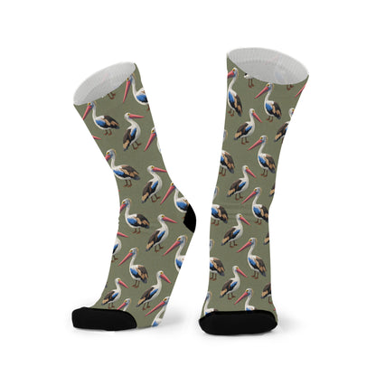 Colourful bamboo socks featuring pelicans on a dark green background.