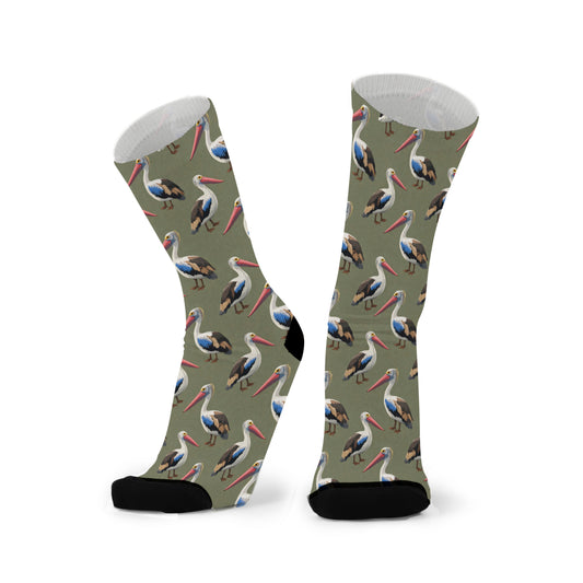 Colourful bamboo socks featuring pelicans on a dark green background.