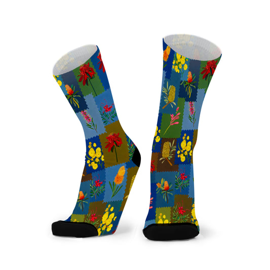 Colourful bamboo socks featuring wattle, banksia and kangaroo paw flower on a multicoloured background.