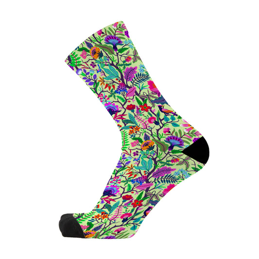 Colourful bamboo socks featuring flowers, leaves and vines on a light green background.