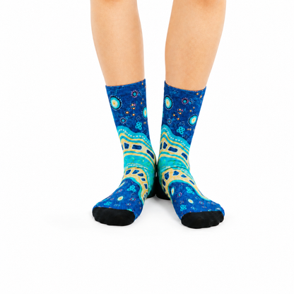 Colourful bamboo socks featuring Indigenous Australian Aboriginal artwork on a blue background.