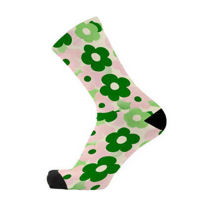 Colourful bamboo socks featuring green flowers on a pink background.