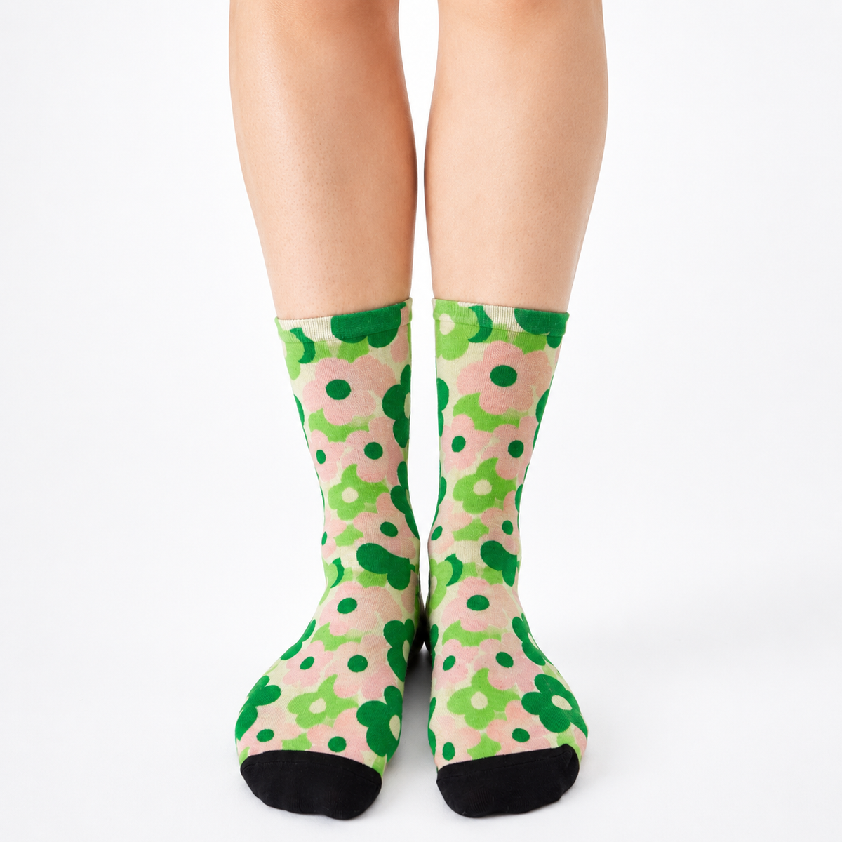 Colourful bamboo socks featuring green flowers on a pink background.