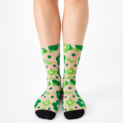 Colourful bamboo socks featuring green flowers on a pink background.