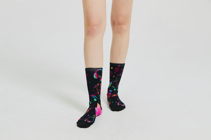 Colourful bamboo socks featuring rainbow music notes and headphones on a black background.