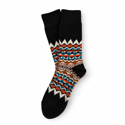 Pair of socks with a colorful pattern on a white background. Scandinavian Style Socks for winter 
