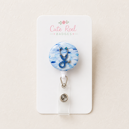 Personalised badge reel with blue floral print and blue stethoscope charm, retractable reel and clip