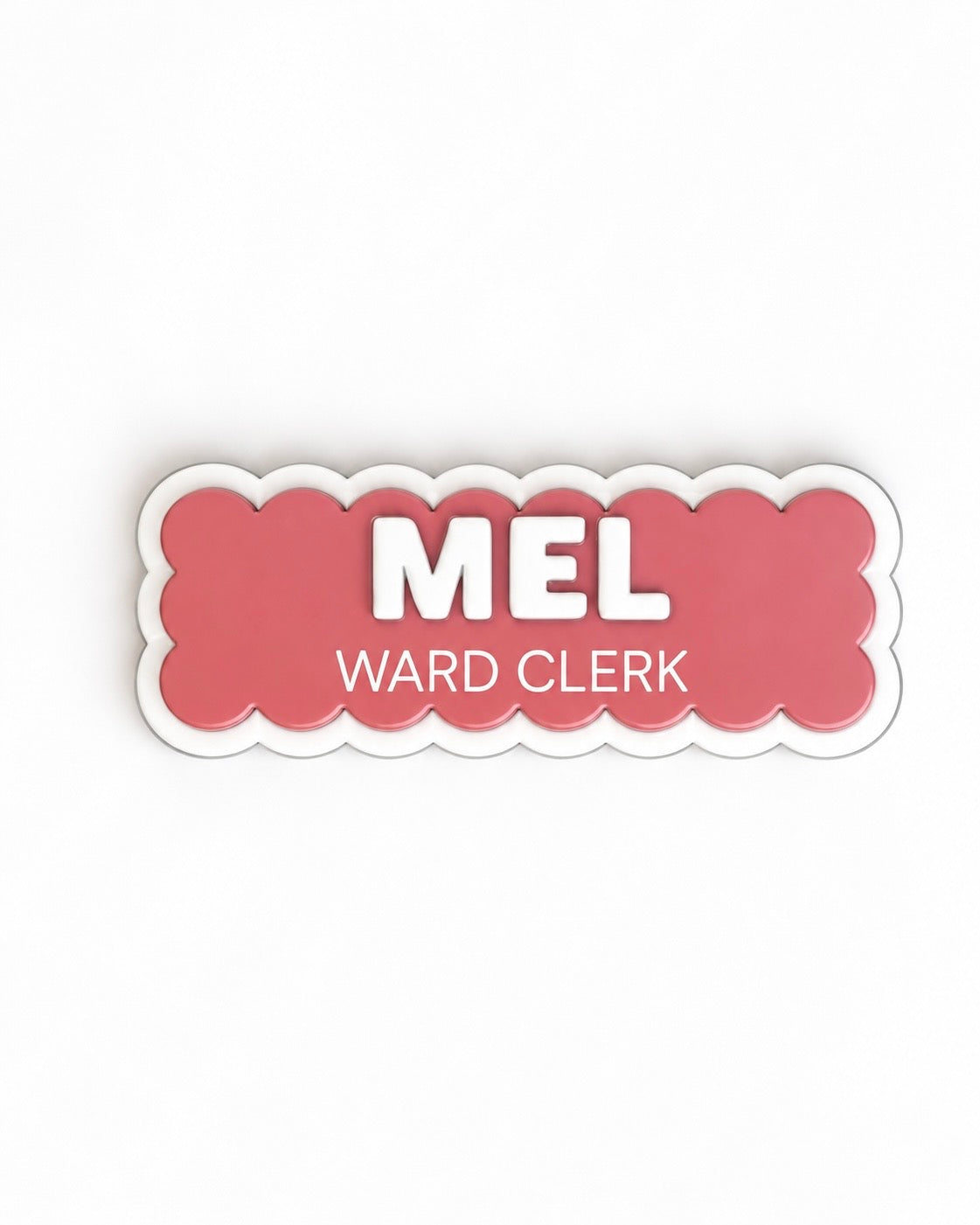 Coral scalloped name badge reading 'Mel – Ward Clerk'