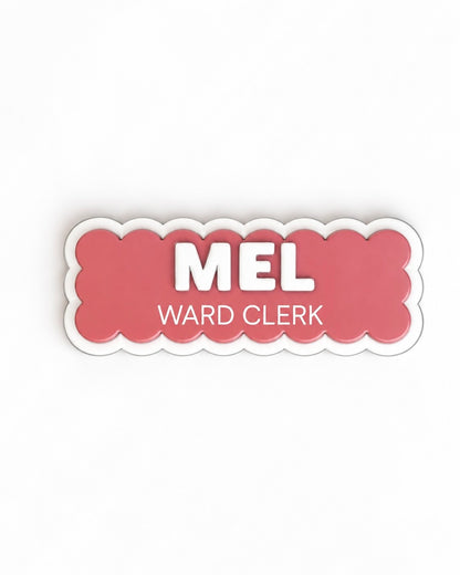 Coral scalloped name badge reading 'Mel – Ward Clerk'
