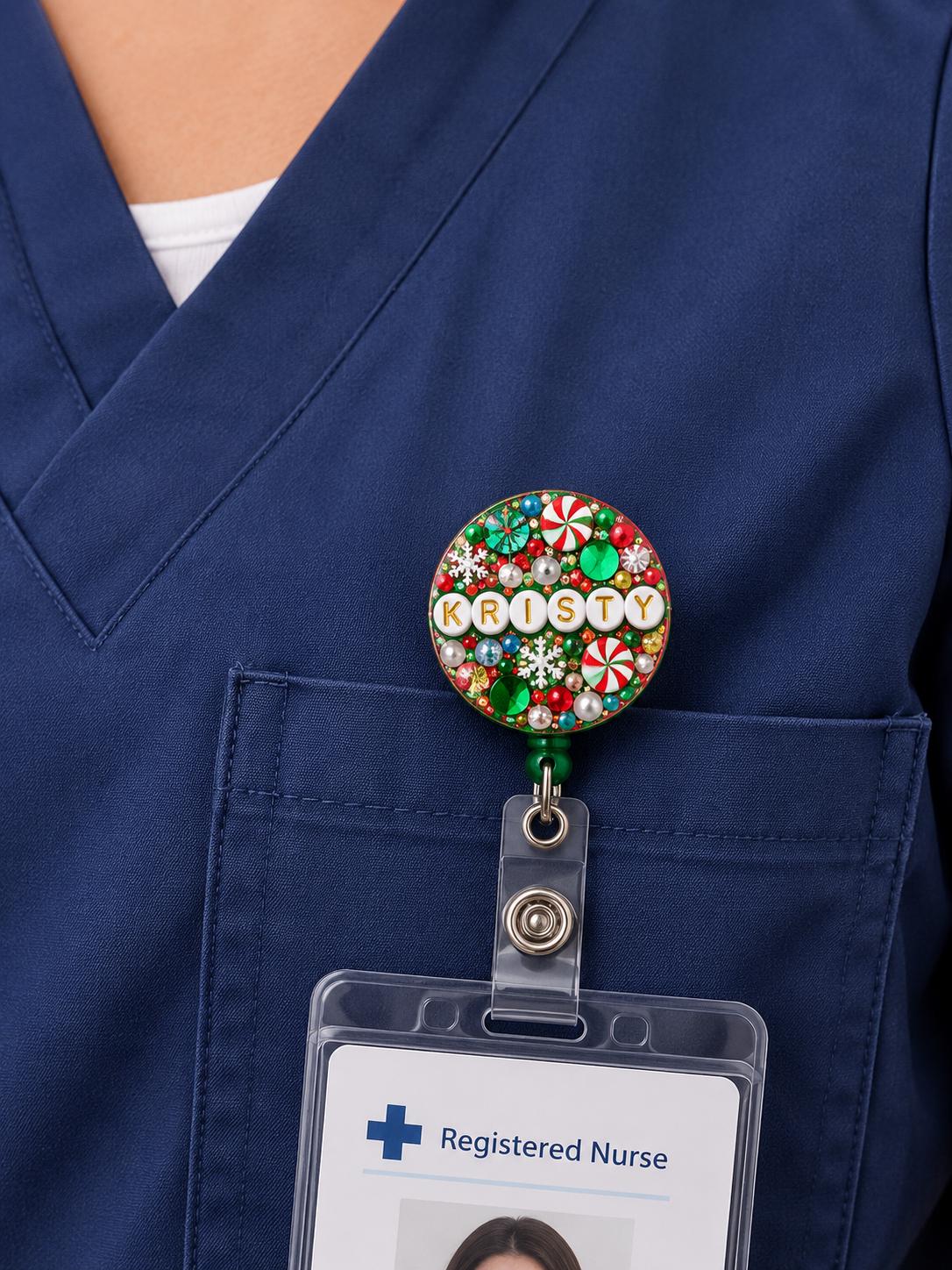 Green Christmas letter bead badge reel worn on navy nurse scrubs holding an ID card