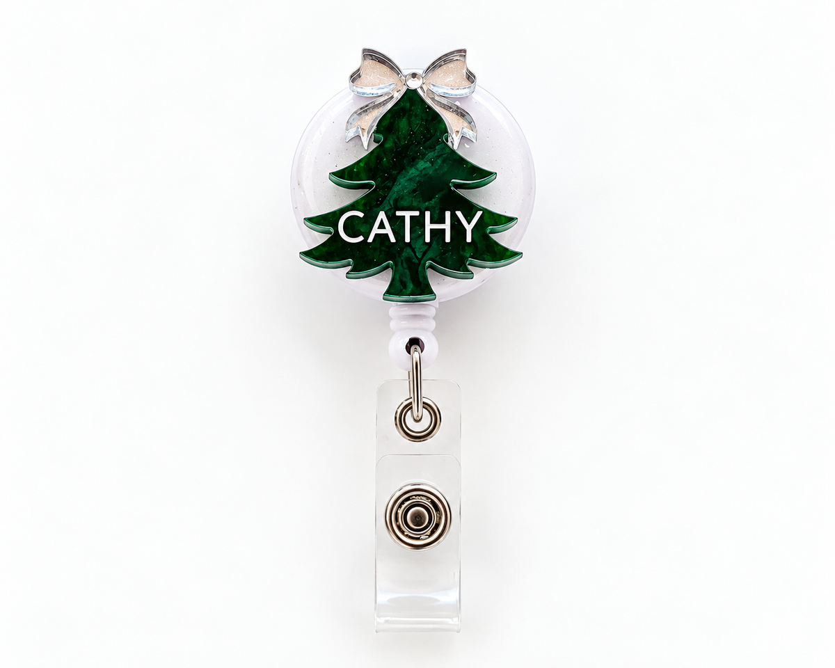Green marble Christmas tree badge reel personalised with the name Cathy and a silver bow