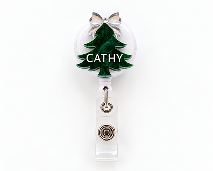Green marble Christmas tree badge reel personalised with the name Cathy and a silver bow