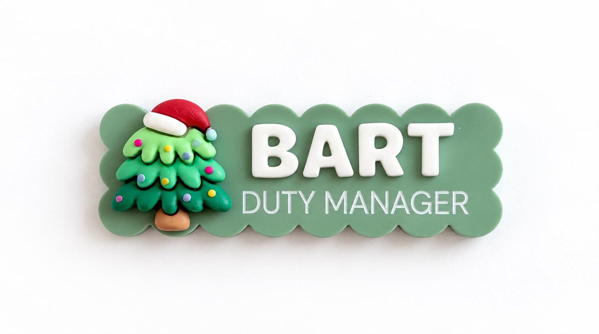 Green scalloped Christmas name badge with a Christmas tree charm reading Bart, Duty Manager