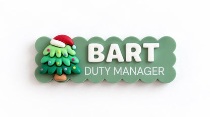 Green scalloped Christmas name badge with a Christmas tree charm reading Bart, Duty Manager