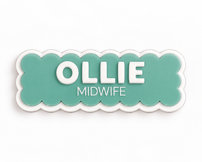 Green scalloped midwife name badge reading 'Ollie – Midwife'