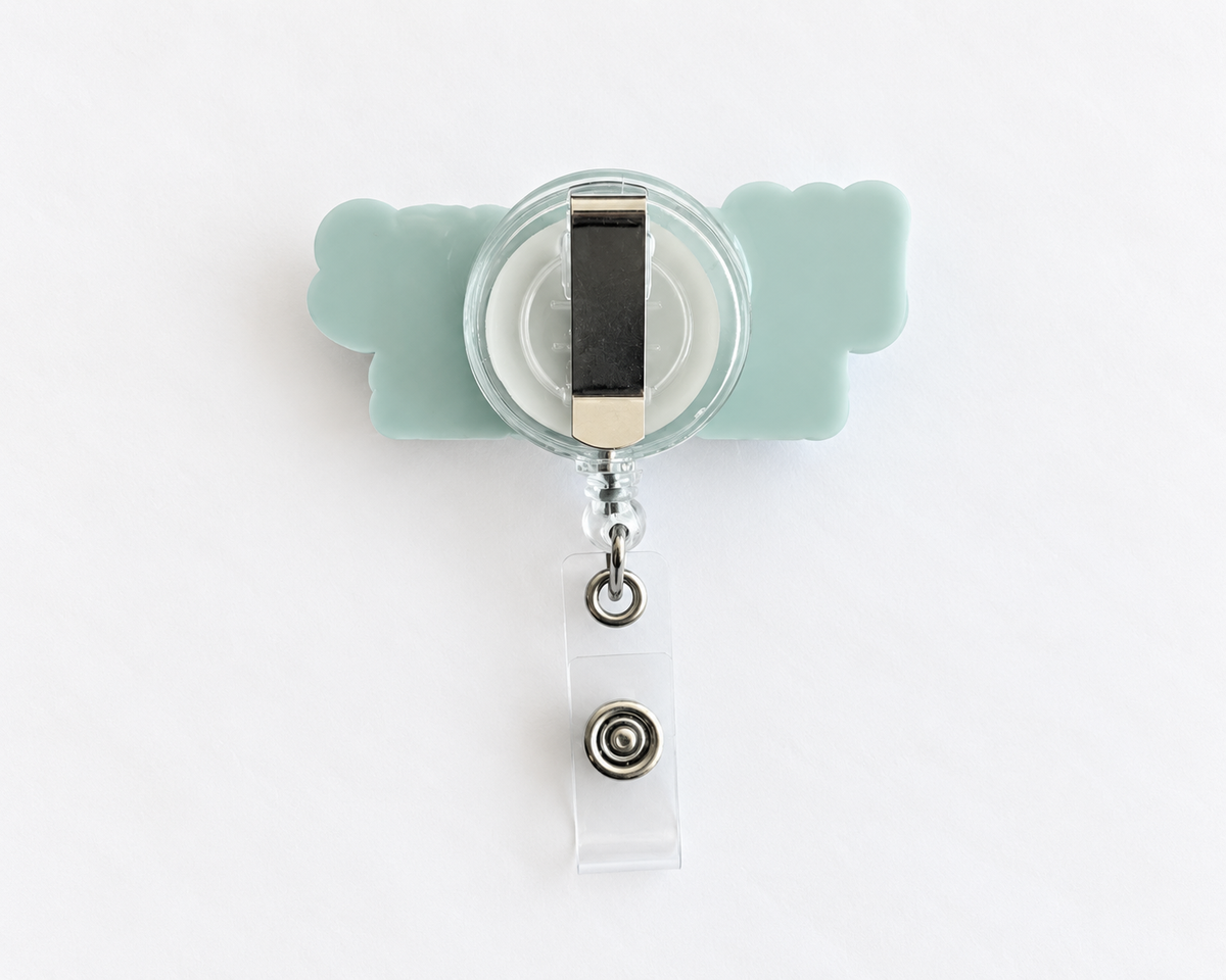 Back of the personalised name badge reel showing the metal clip, retractable cord and clear ID card strap with snap
