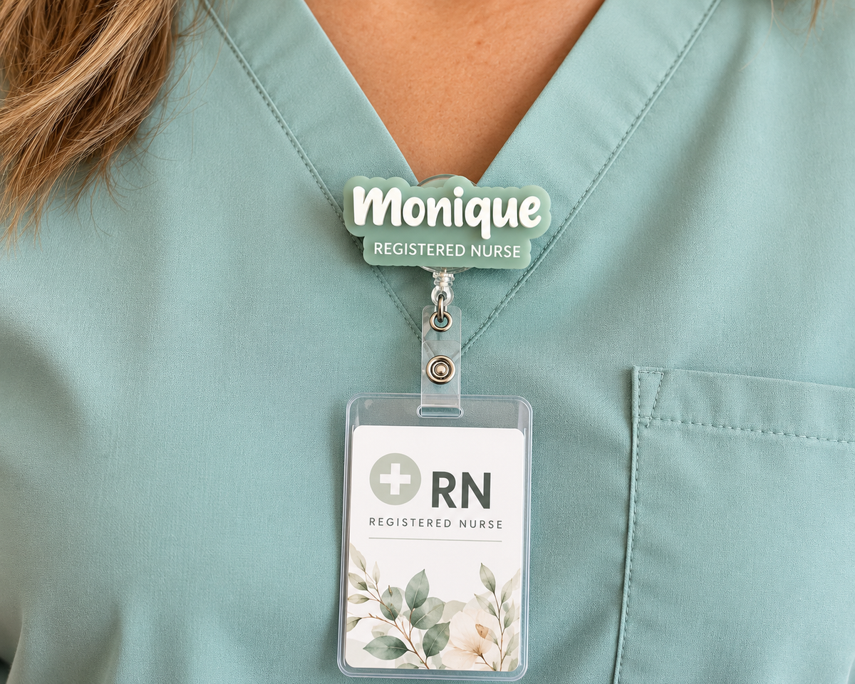 Nurse wearing a sage 'Monique – Registered Nurse' 3D name badge reel holding an ID card on teal scrubs