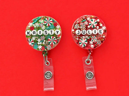 Kristy and Julie personalised Christmas letter bead badge reels on a red background