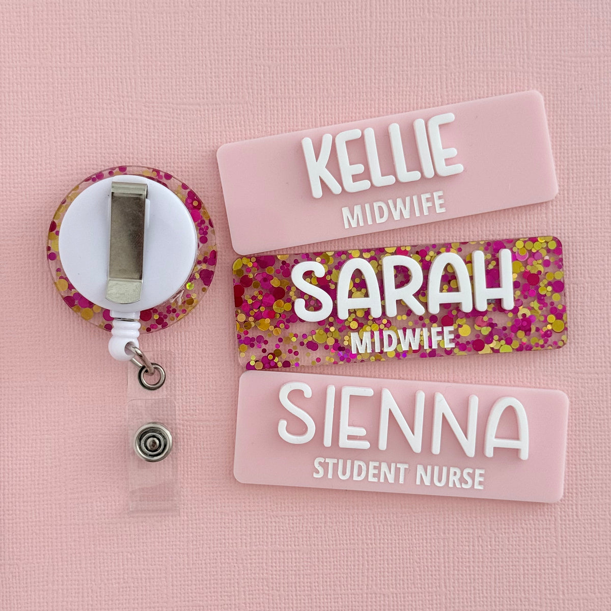 Pink glitter badge reel with pastel pink Kellie Midwife, Sarah Midwife and Sienna Student Nurse name badges