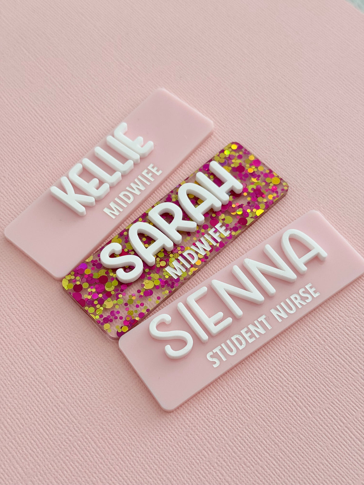 Pink glitter and pastel pink personalised name badges reading Kellie, Sarah and Sienna