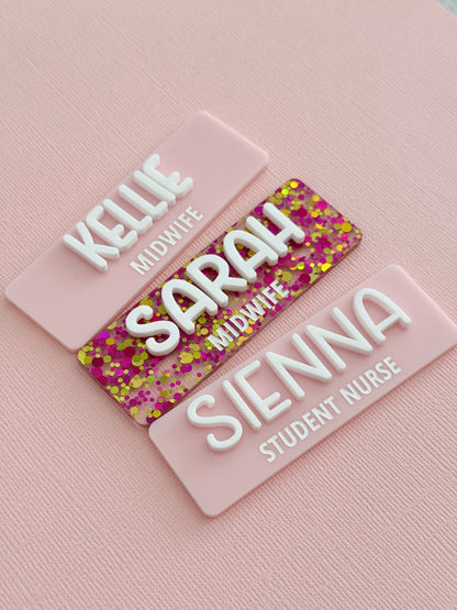 Pink glitter and pastel pink personalised name badges reading Kellie, Sarah and Sienna