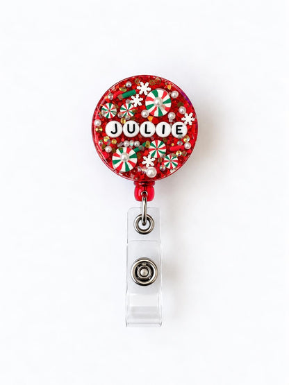 Red Christmas letter bead badge reel with the name Julie in white letter beads
