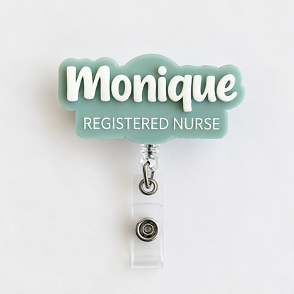 Personalised sage acrylic name badge reel with 'Monique' in raised white 3D lettering and 'Registered Nurse' underneath