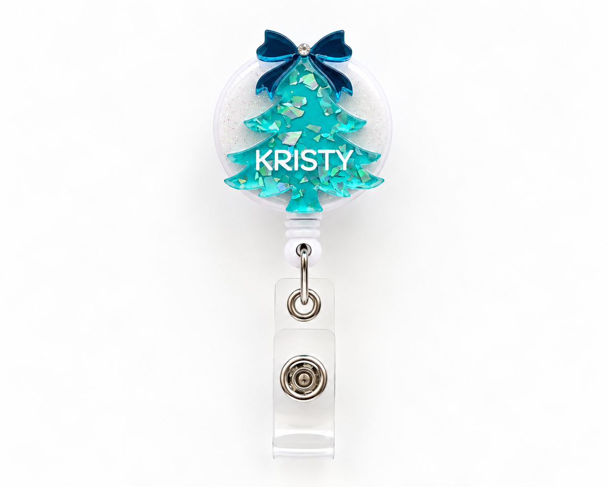 Teal glitter Christmas tree nurse badge reel personalised with the name Kristy and a navy bow
