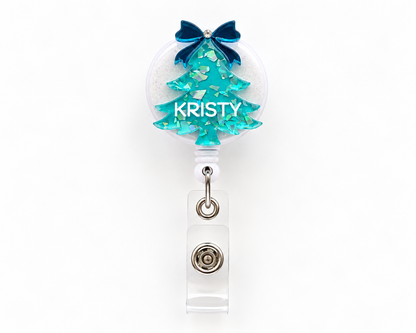 Teal glitter Christmas tree nurse badge reel personalised with the name Kristy and a navy bow